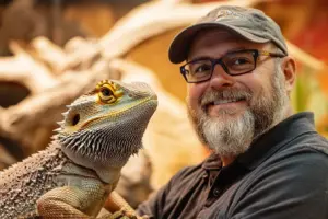 showing Max Brimley himself, laughing and his bearded dragon on the left side of the image